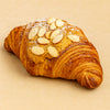 Croissant with almonds on a beige background harlem halo bagels