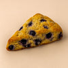 Blueberry scone on a beige background harlem halo bagels