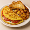 Omelette with tomatoes, toast, and roasted potatoes on a white plate. halo bagels harlem